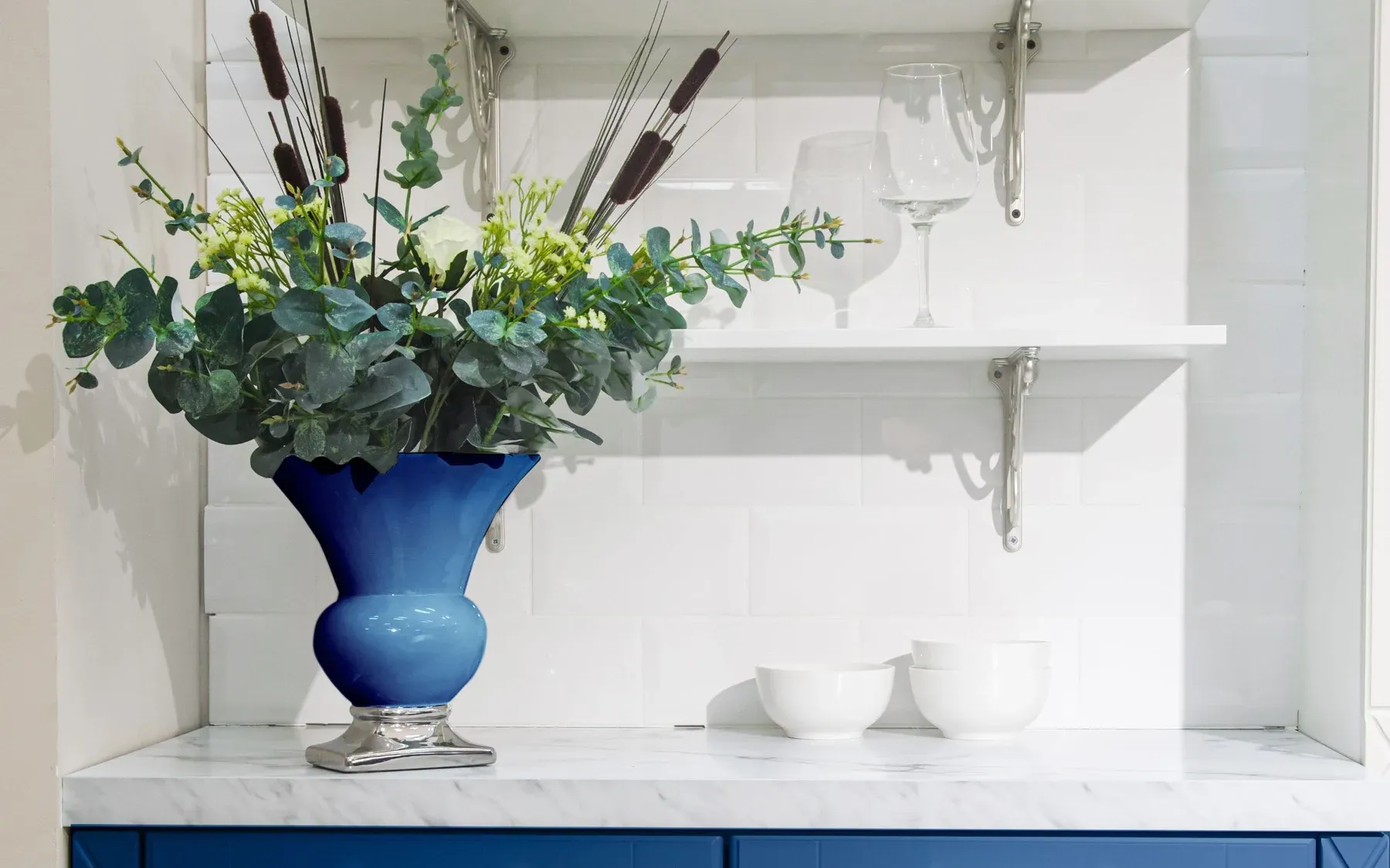 White shelves with a blue vase