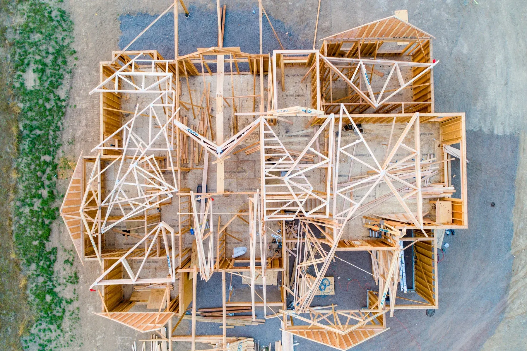 Aerial view of a custom home being framed